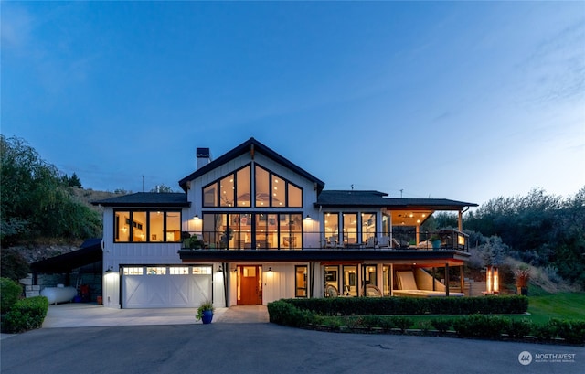 exterior space with a garage and a balcony