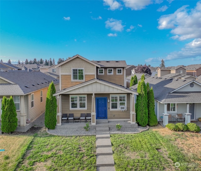 view of front of home featuring a front lawn and a patio area