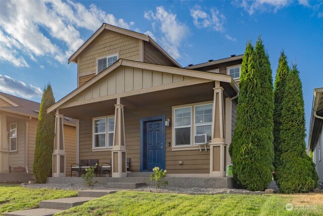 view of front of house with cooling unit and covered porch