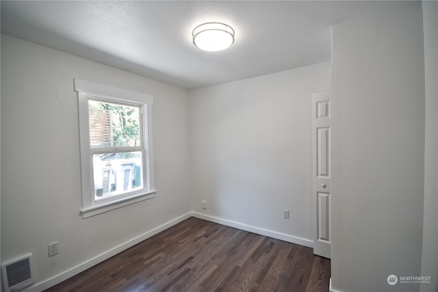 spare room with dark hardwood / wood-style flooring