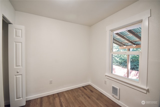 spare room with dark wood-type flooring