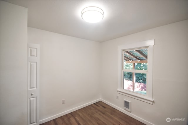 empty room featuring dark wood-type flooring