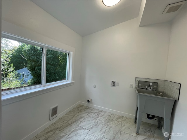 laundry area with hookup for a washing machine and heating unit