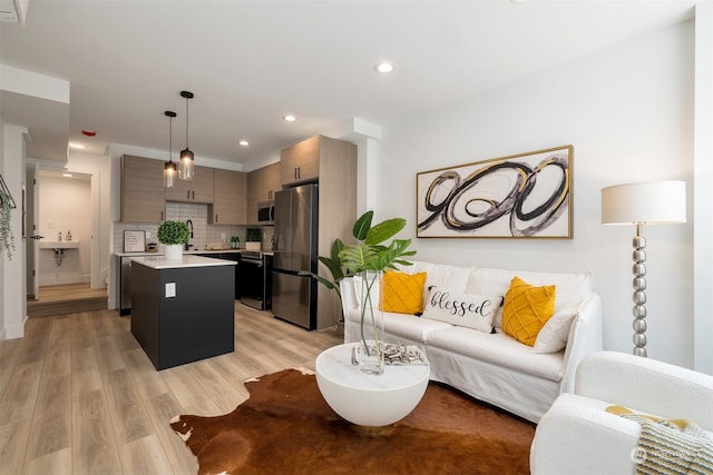 living room with sink and light hardwood / wood-style floors