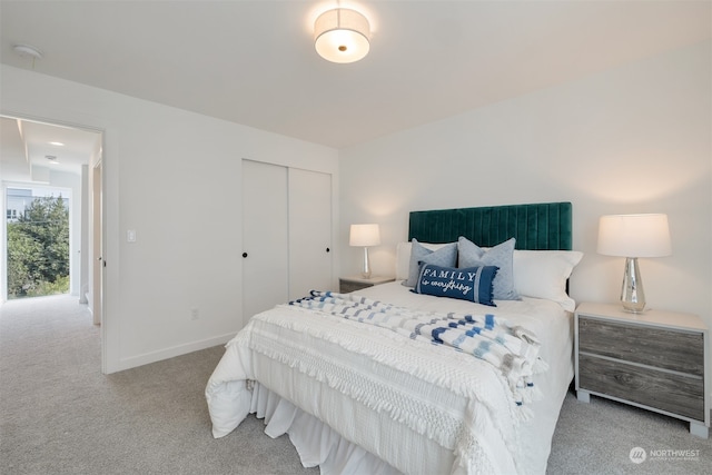 bedroom with a closet and light carpet