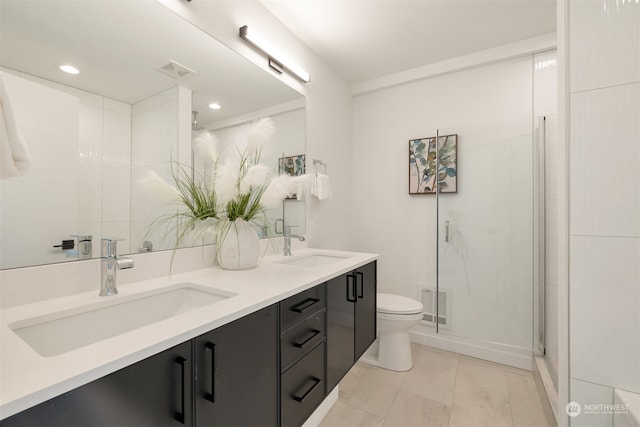 bathroom featuring vanity, toilet, tile patterned floors, and walk in shower