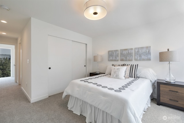 bedroom with a closet and light colored carpet