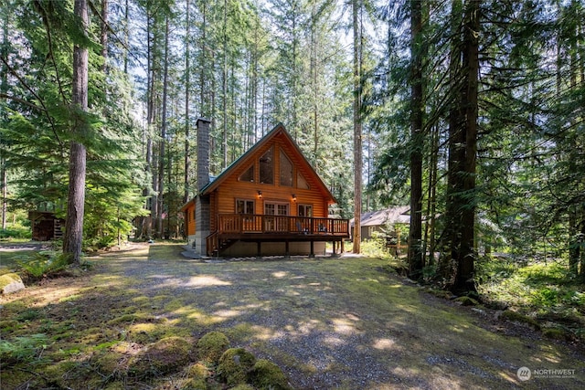 rear view of property with a wooden deck