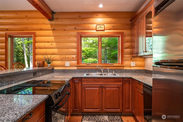 kitchen with sink, black appliances, beam ceiling, and log walls