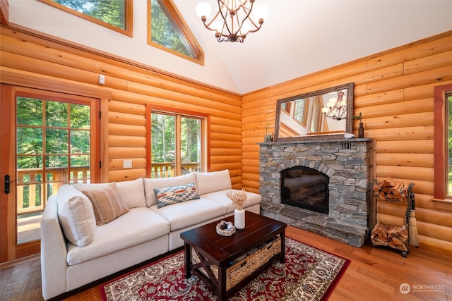 living room with high vaulted ceiling, a stone fireplace, rustic walls, and hardwood / wood-style flooring