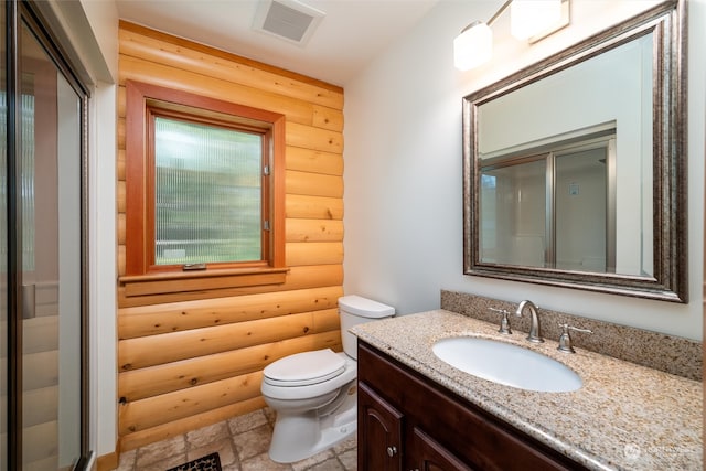 bathroom featuring toilet, rustic walls, an enclosed shower, and vanity