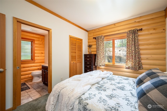 bedroom with ensuite bath, crown molding, a closet, and log walls