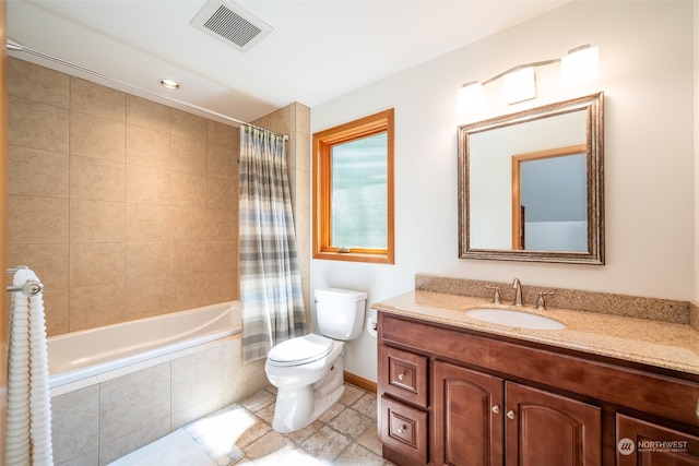 full bathroom featuring toilet, vanity, and shower / bathtub combination with curtain