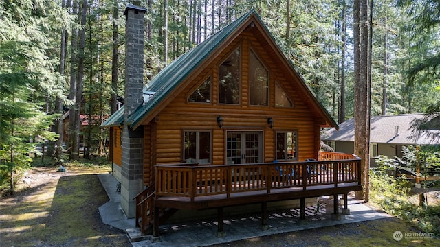 rear view of property featuring a wooden deck