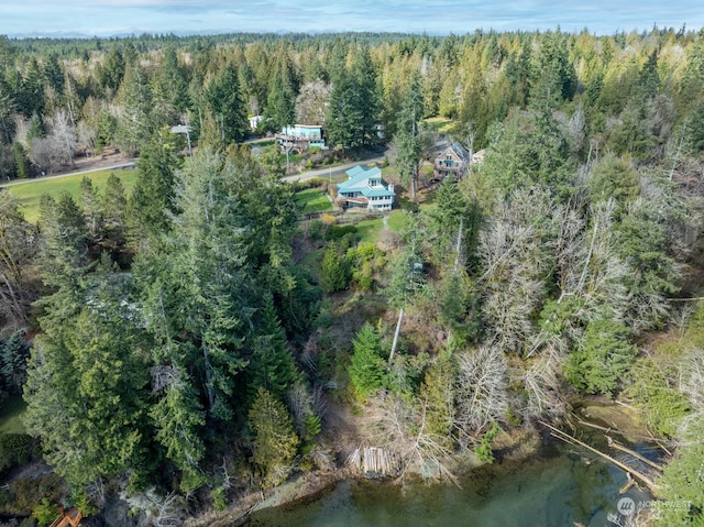 birds eye view of property with a forest view and a water view