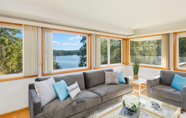 sunroom / solarium featuring a wealth of natural light and a water view