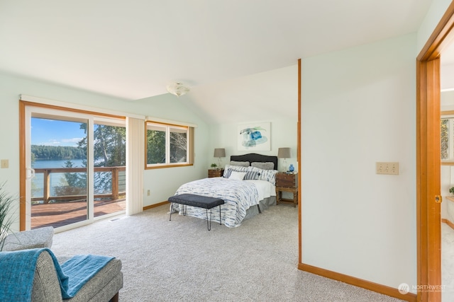 bedroom with carpet floors, a water view, baseboards, vaulted ceiling, and access to outside