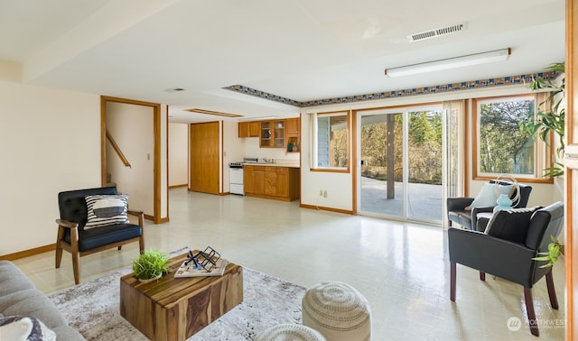 living room featuring light floors, visible vents, and baseboards