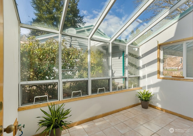 unfurnished sunroom with a skylight