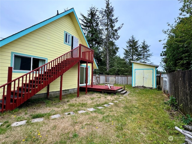 view of yard featuring a wooden deck and a storage shed