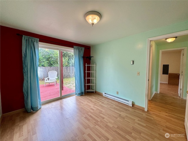 spare room featuring light hardwood / wood-style flooring and baseboard heating