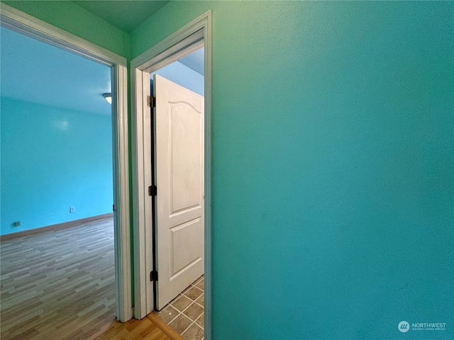 corridor with hardwood / wood-style floors