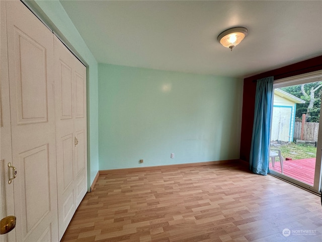 unfurnished bedroom with light hardwood / wood-style flooring, access to outside, and a closet