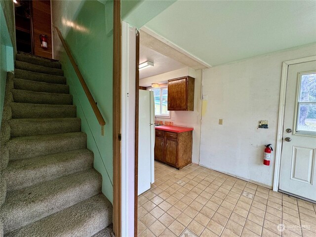 stairs featuring tile patterned floors