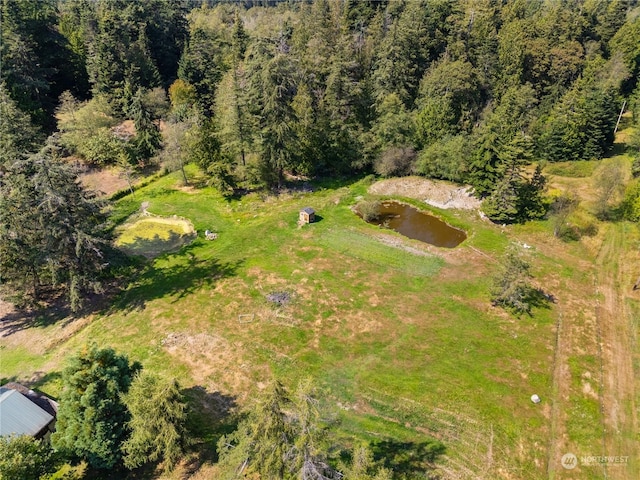 drone / aerial view featuring a forest view