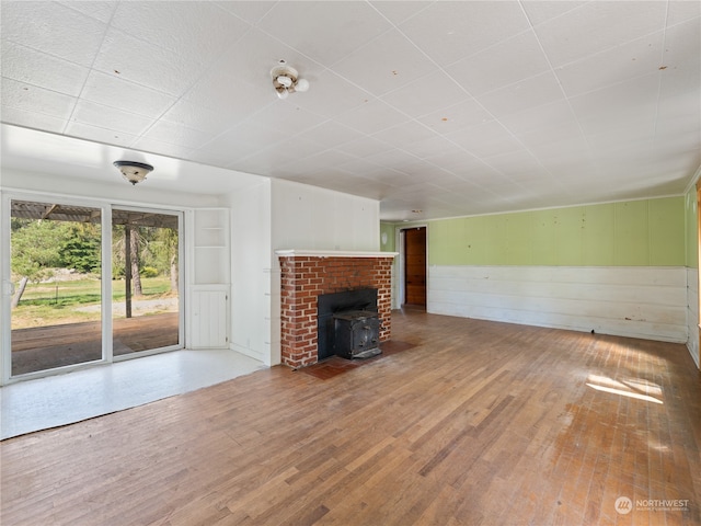 unfurnished living room featuring a fireplace and light hardwood / wood-style flooring