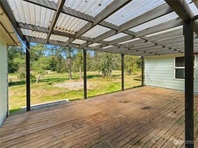 wooden deck with a lawn and a pergola