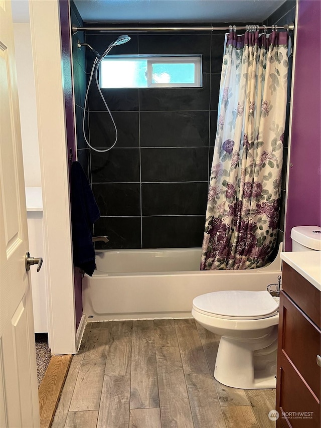 full bathroom with vanity, hardwood / wood-style floors, shower / bath combination with curtain, and toilet