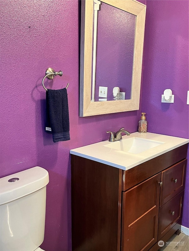 bathroom with vanity and toilet