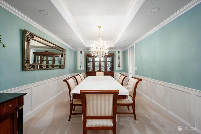 dining space featuring a notable chandelier, light colored carpet, a raised ceiling, and crown molding