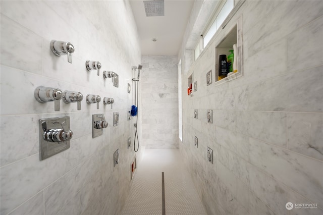 corridor featuring tile walls and tile patterned floors