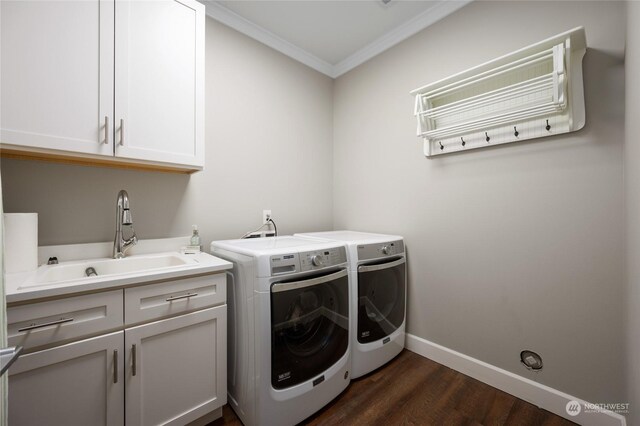 laundry area featuring cabinets, sink, washing machine and clothes dryer, dark hardwood / wood-style flooring, and ornamental molding