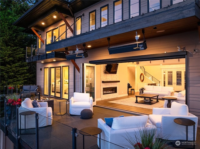 exterior space featuring an outdoor hangout area, a balcony, french doors, and a patio