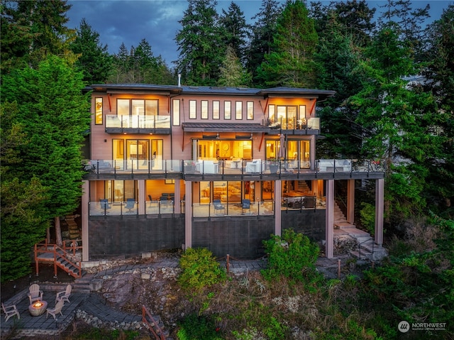 rear view of property with a balcony and a patio area