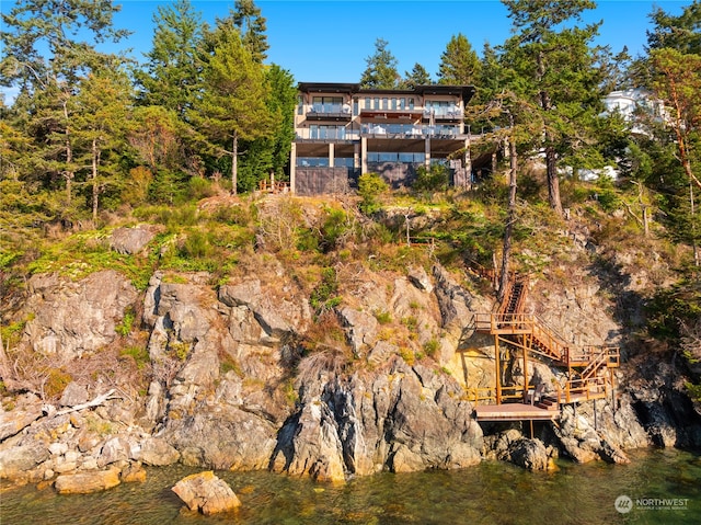 rear view of property with a water view