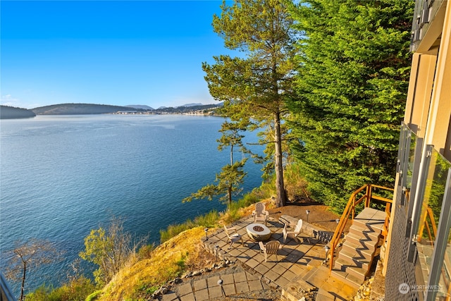 water view with a mountain view and a fire pit