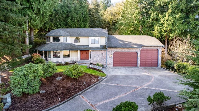 view of front of property featuring a garage and a porch