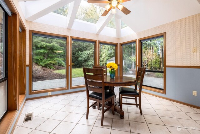 dining room featuring light tile patterned floors, visible vents, ceiling fan, and wallpapered walls