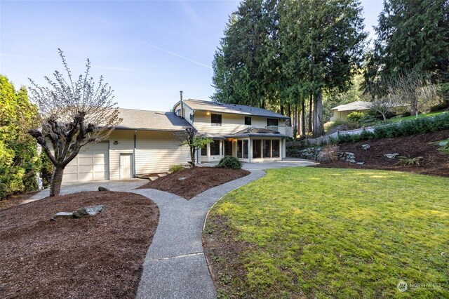 traditional home with an attached garage and a front yard