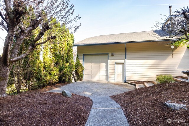 garage featuring concrete driveway