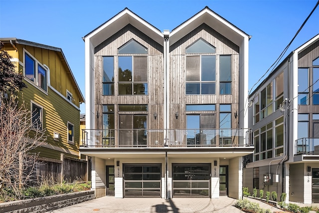 view of front of property with a garage and a balcony