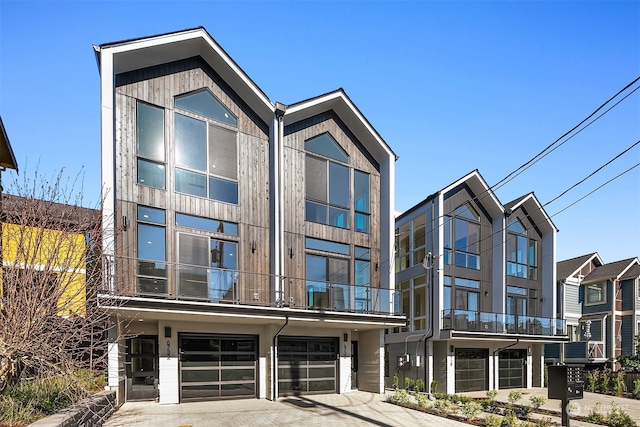 modern home featuring a balcony and a garage