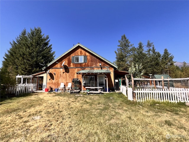 back of house with a lawn and a patio area