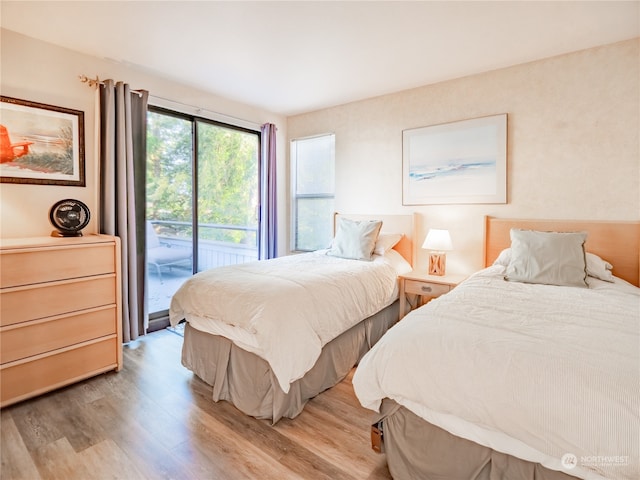 bedroom featuring light hardwood / wood-style flooring and access to exterior