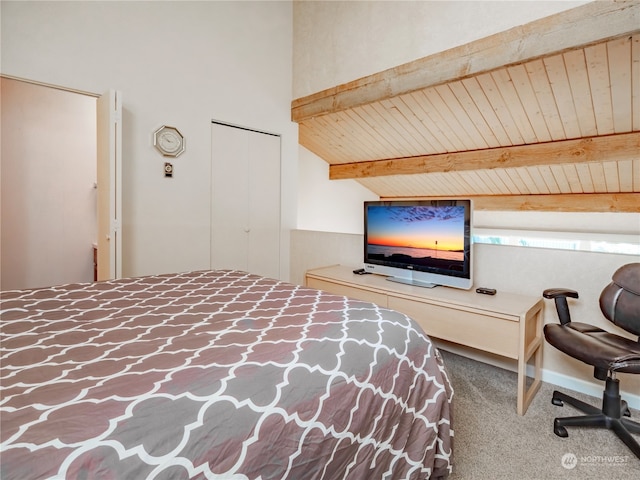 bedroom with lofted ceiling with beams and carpet floors