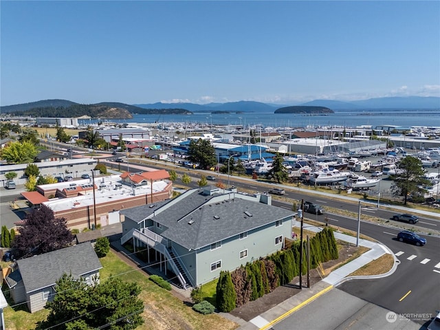 drone / aerial view with a water and mountain view